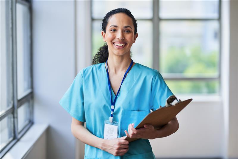 Imaging 1 Female medical professional in scrubs holding a clipboard