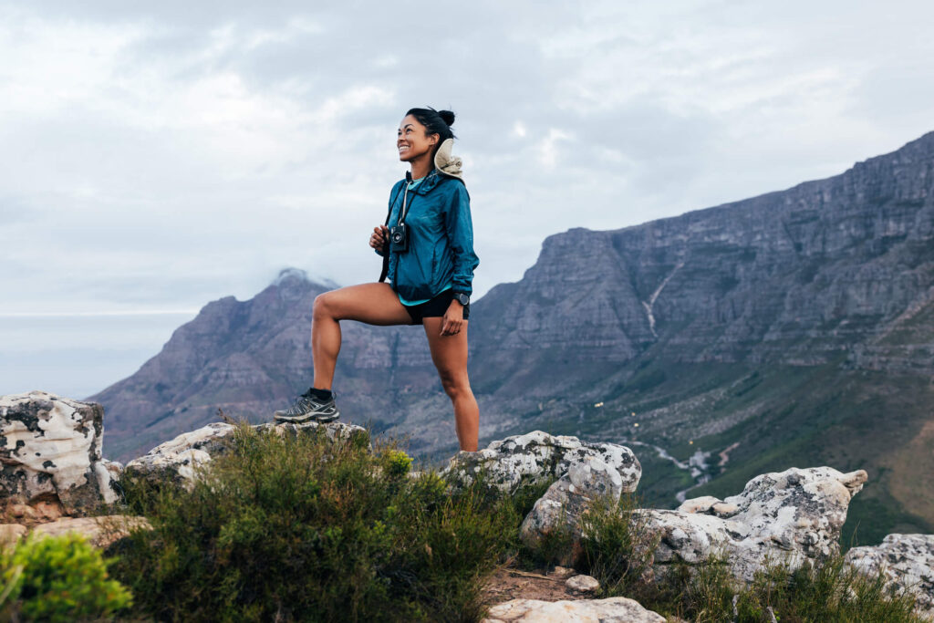 Happy woman hiking in mountains